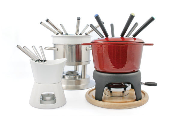 Swissmar Sierra Cast Iron Fondue Set, shows black base and white pot with wooden coaster. Image includes fondue forks and burner.