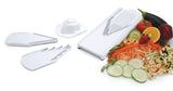 Borner V-Slicer White Plus Mandoline White with Safety Holder and inserts spread out with sliced vegetables in the background