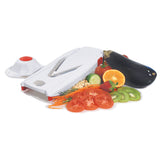 Vslicer in white with safety holder on one side and assorted sliced vegetables on the other side