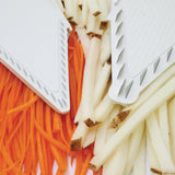 Close up of julienne inserts with sliced carrots and potatoes underneath to show the size of slices